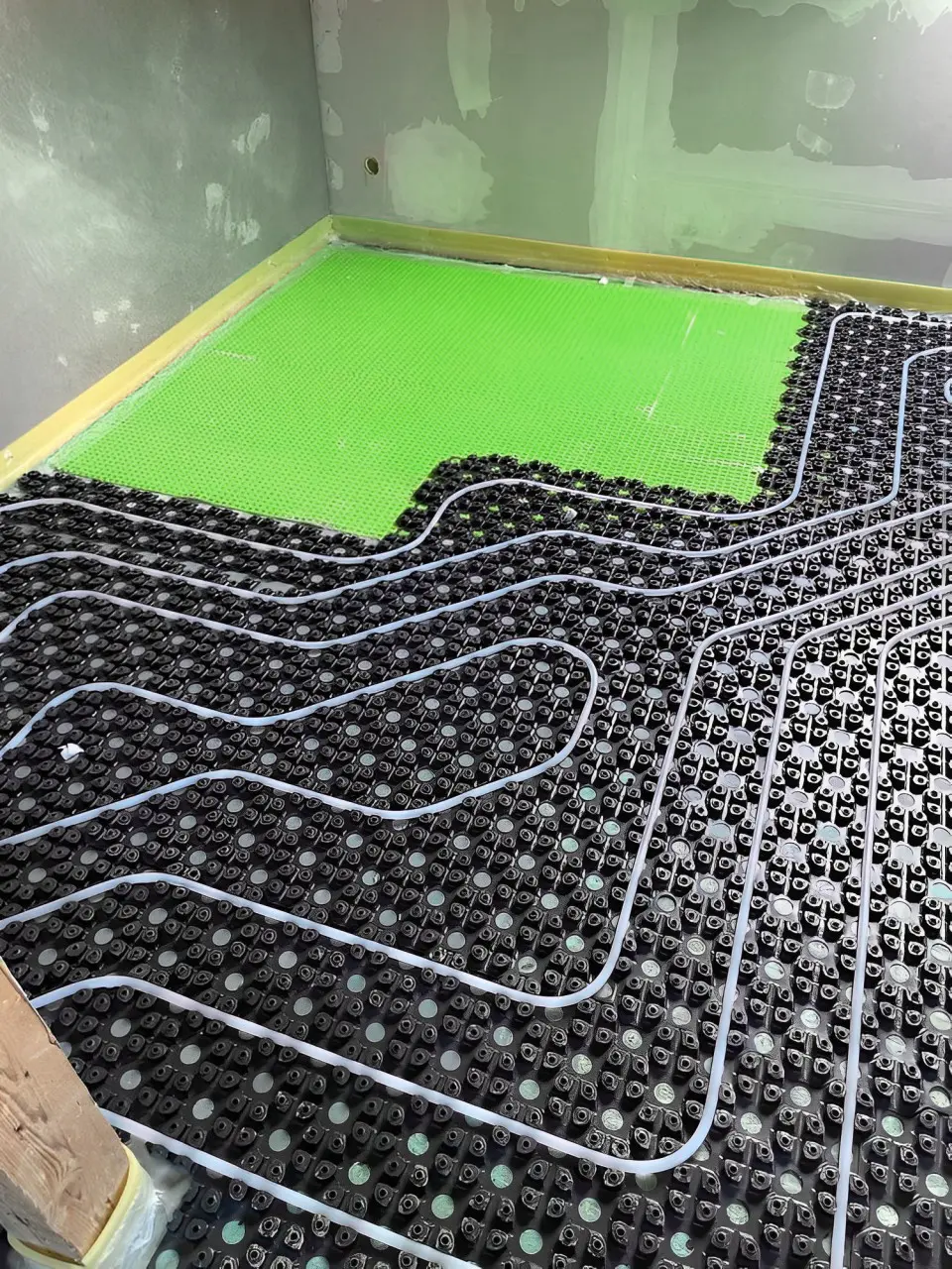 MC Therm NerthusFlow thin-layer system studded sheet installed with green HydroShield Plus decoupling mat.